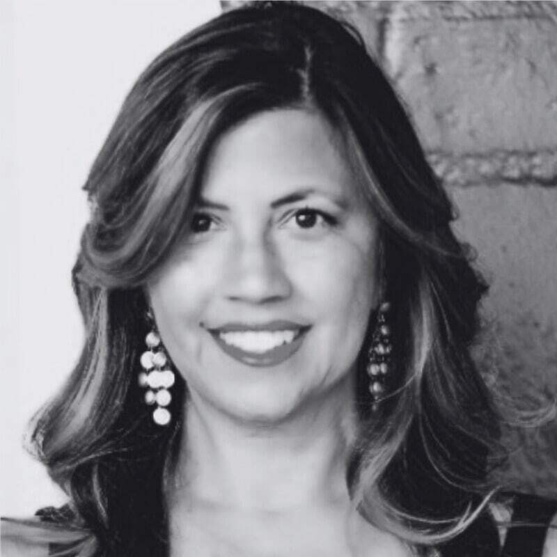Monika Madrid is pictured in a professional, black and white headshot.