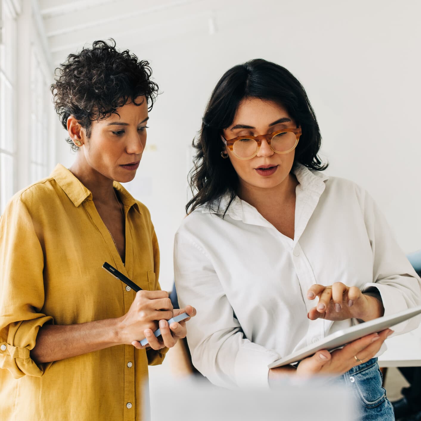 Two women are evaluating a quantitative survey design.