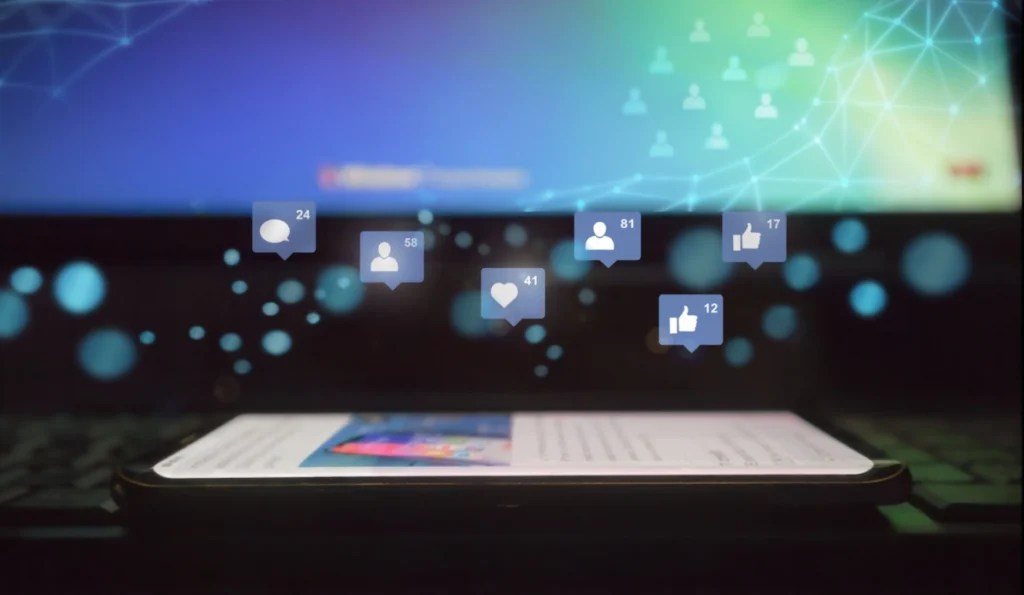 Phone laying on surface with digital projections of like symbols float above it