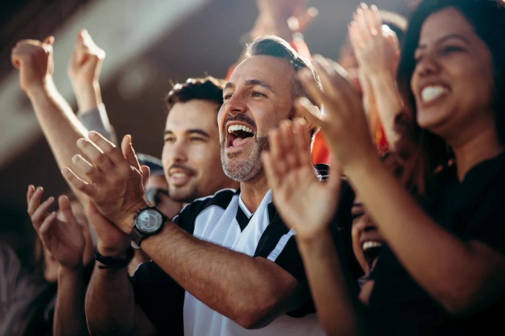 A group of sports fans clapping