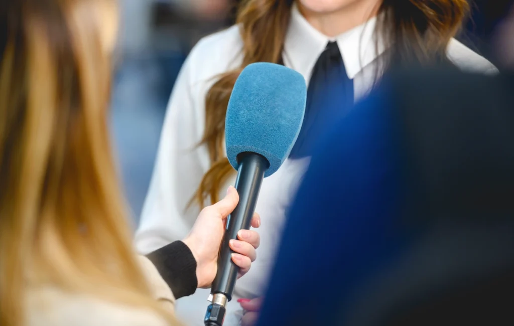 Journalist with microphone getting time back and promoting the Collaborator Analyze tool