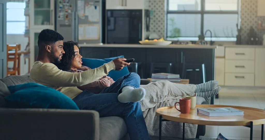 image to represent blog on FAST audience insights - couple sitting in front of a tv