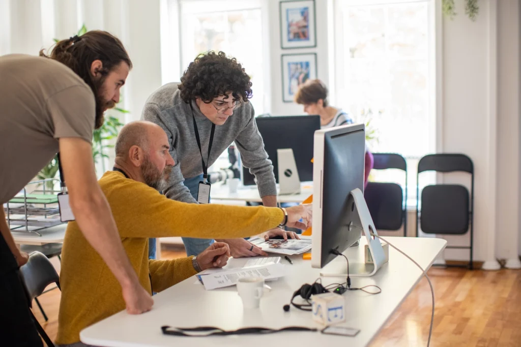 Voice drift in the era of AI - People working together around a computer